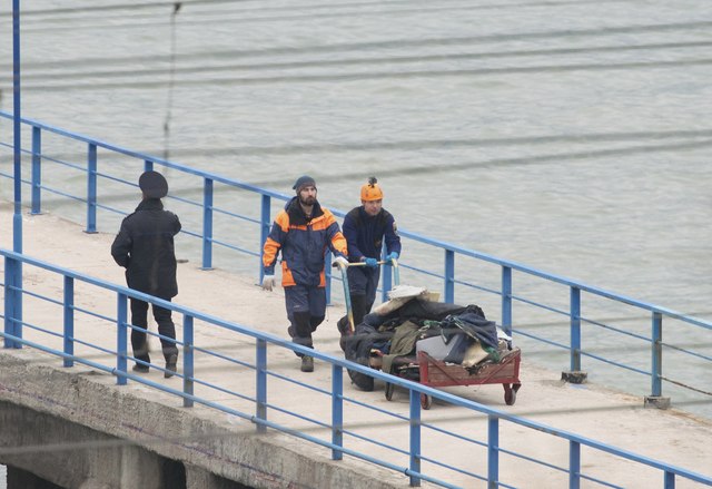 Các thành viên của Bộ Cứu trợ Khẩn cấp Nga chở các vật thể tìm kiếm được từ khu vực máy bay rơi ở gần Sochi và đưa lên bờ. (Ảnh: Reuters)