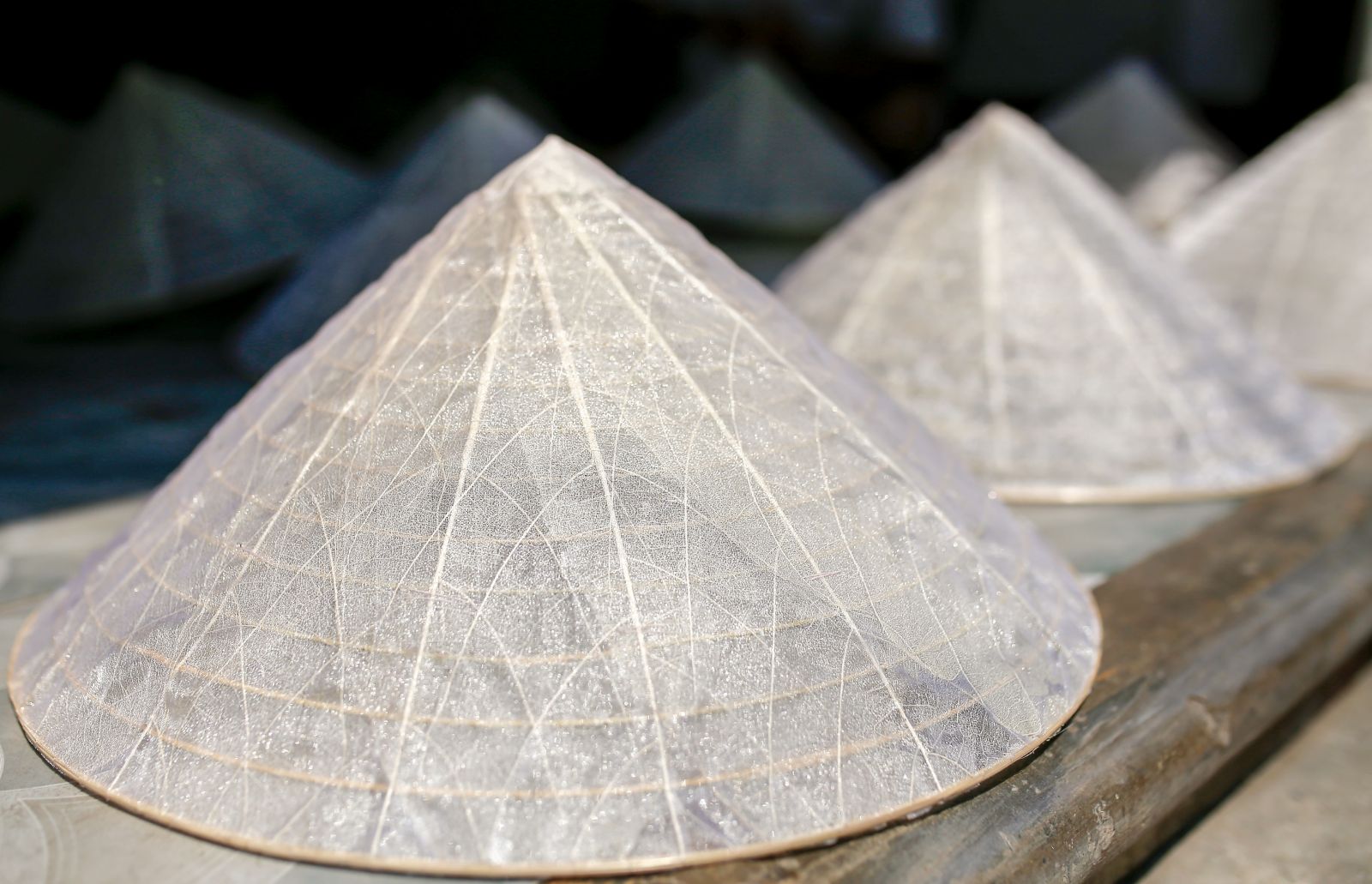 The transparent leaf veins conical hats are finished, with their strange beauty of elegance and luxury.