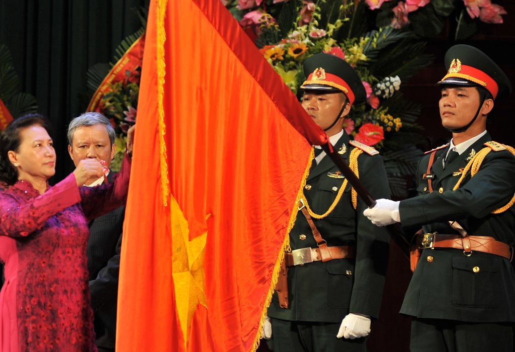 The First-class Independence Medal is pinned on the National Flag by the National Assembly Chairwoman on behalf of the Party and the State
