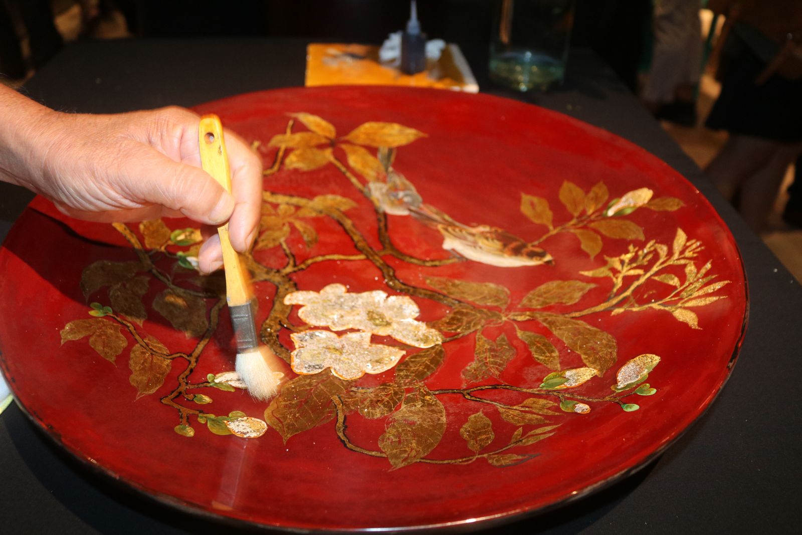 An artisan gilding a lacquer painting