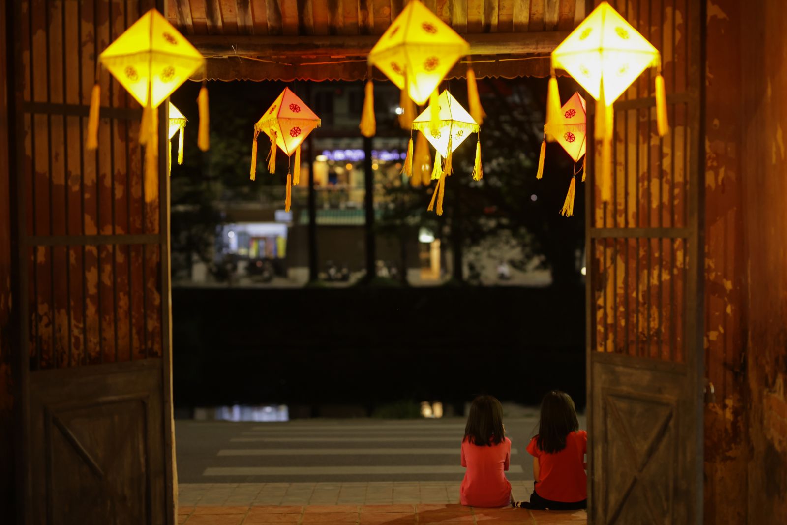 Two little girls with their families enjoying the atmosphere of the approaching Vesak