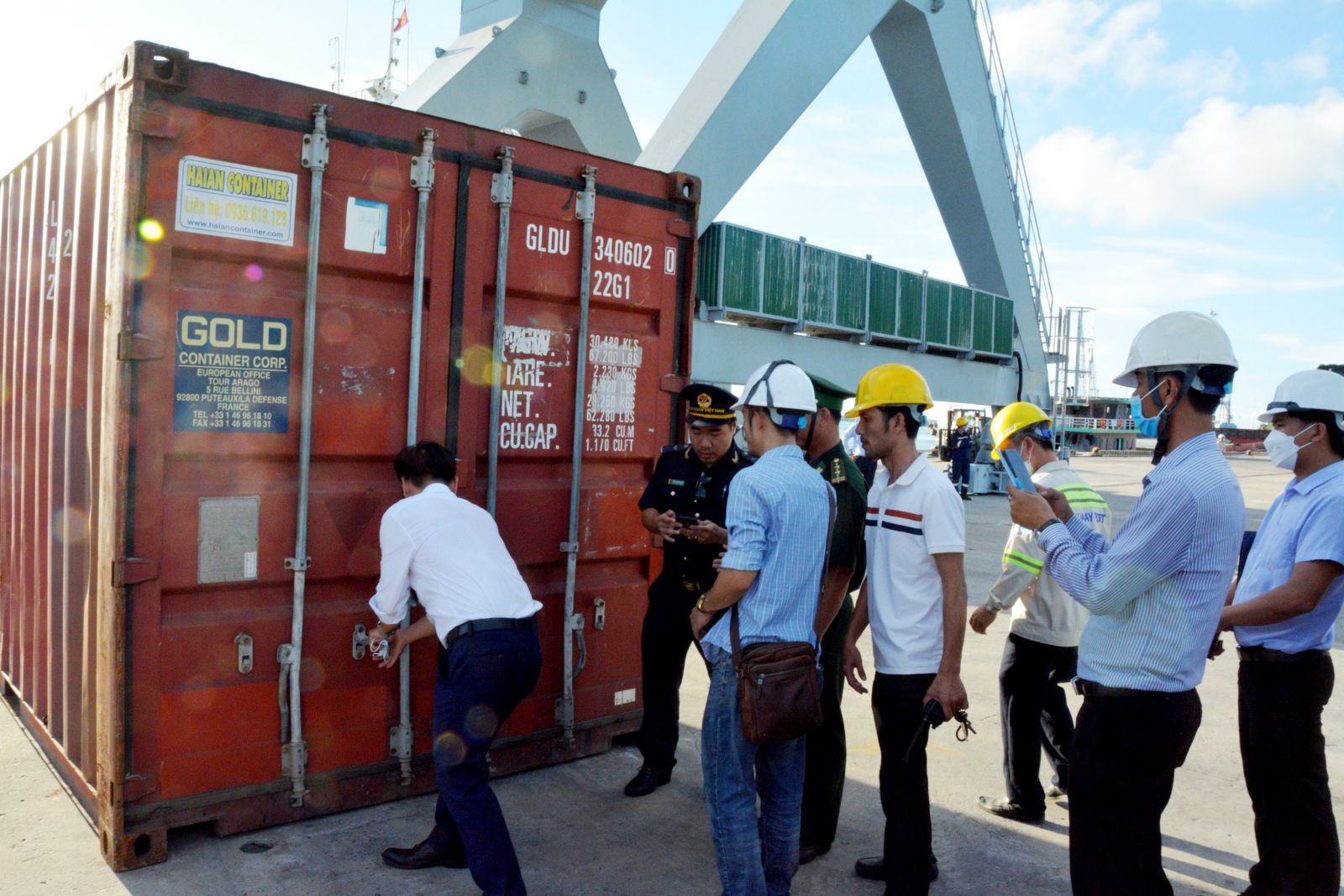 Customs forces checking the condition inside the container after its being unloaded from the ship