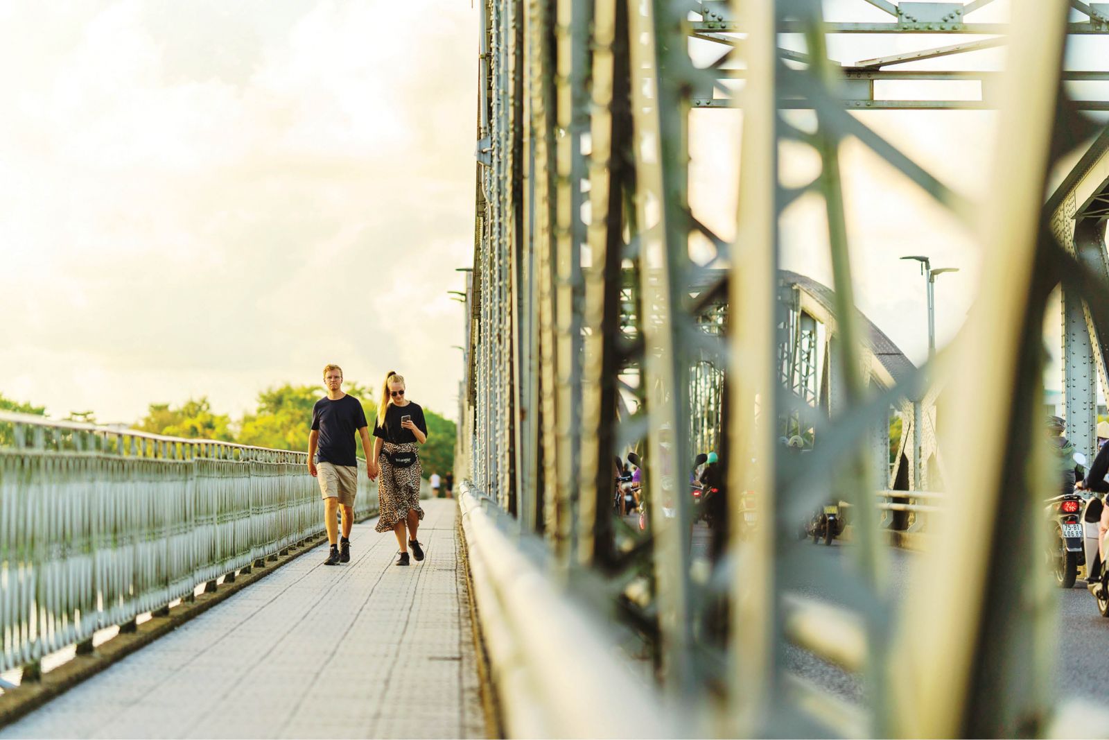 Tourists jogging through Truong Tien Bridge