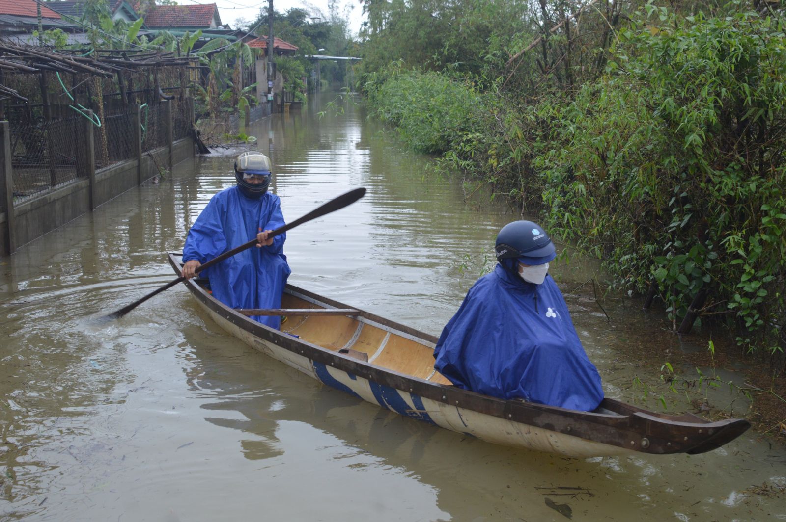 People in low-lying areas traveling by boat