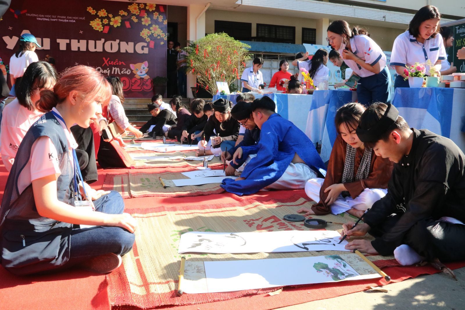Korean students watching calligraphers writing calligraphy
