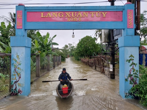 Prolonged rain causes people in low-lying areas to travel by boat